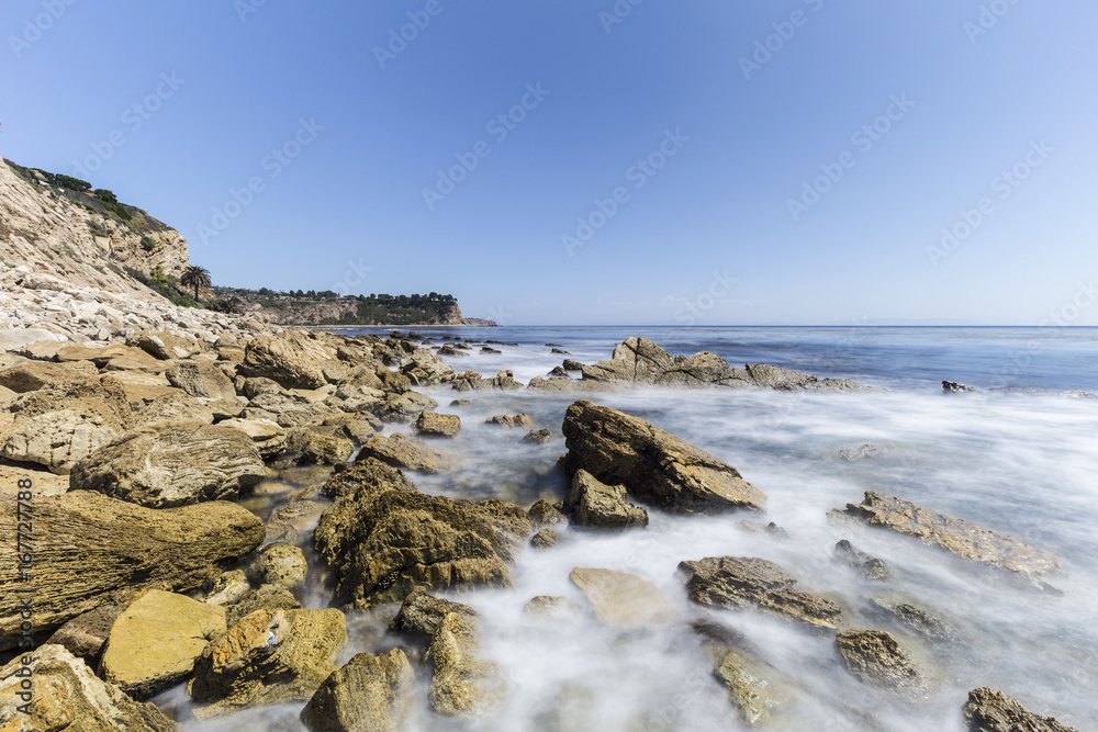 Rocky Palos Verdes Estates coast with motion blur waves in Los Angeles County, California.  