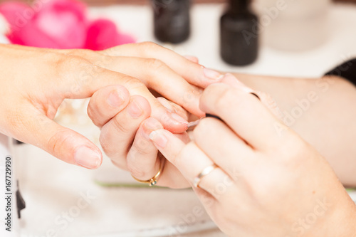 Laying nail polish on a woman's hands