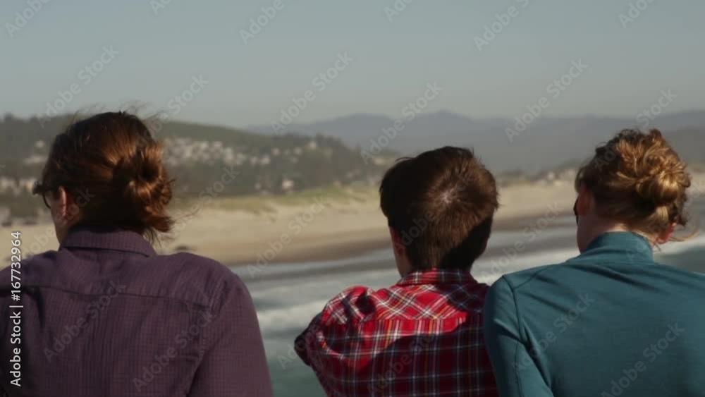 Closeup Of A Group Of Friends Enjoying The View From A Sea Cliff Closeup Of A Group Of Friends Enjoying The View From A Sea Cliff