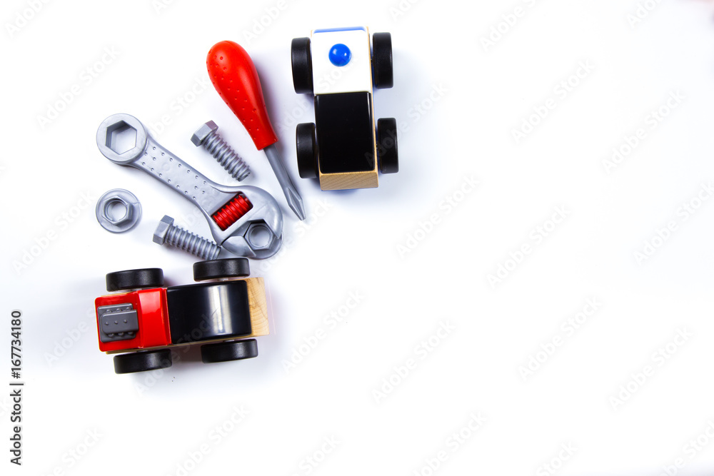 Kids toys frame with construction blocks, cubes, toy tools and cars on white background. Top view Kids toys frame with construction blocks, cubes, toy tools and cars on white background. Top view