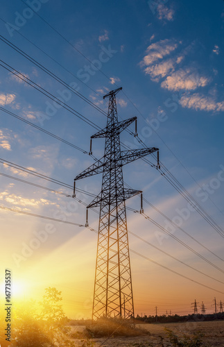 high-voltage power lines at sunset. electricity distribution station. high voltage electric transmission tower.