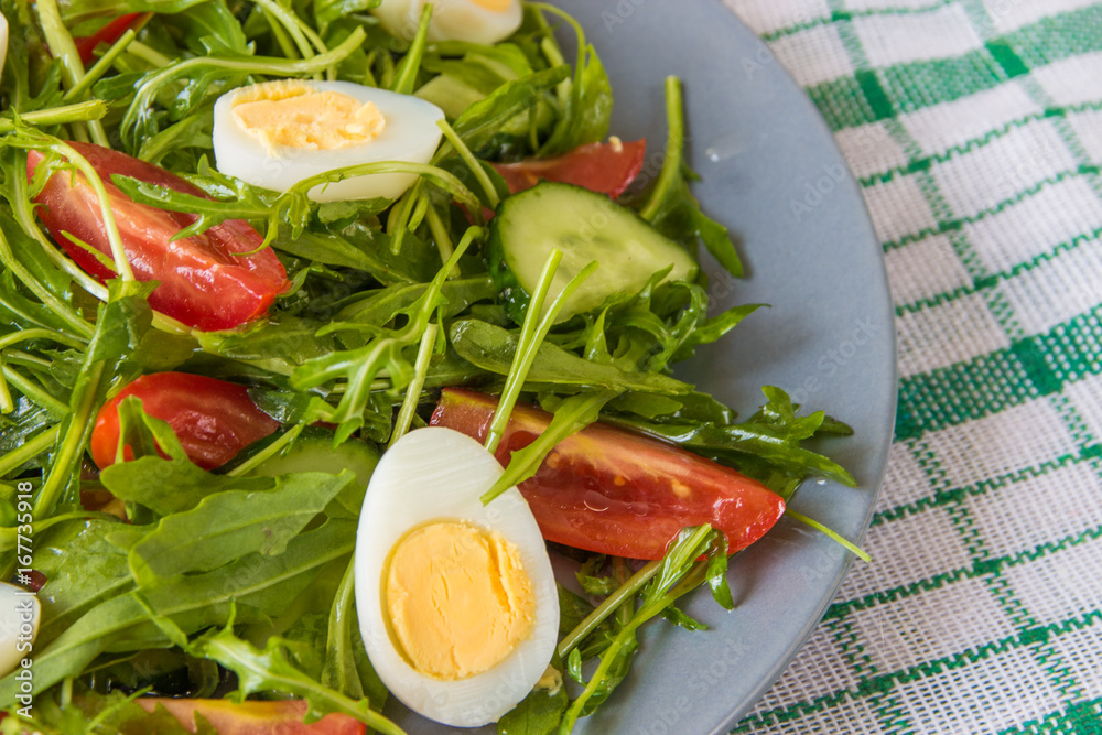 Fresh green salad with arugula, tomatoes, eggs and cucumber Fresh green salad with arugula, tomatoes, eggs and cucumber