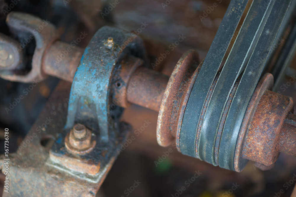 Part of the old rusty gearbox and drive shaft with grunge oil dirty. Part of the old rusty gearbox and drive shaft with grunge oil dirty.