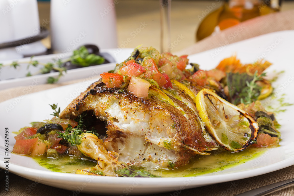 Fried fish with vegetables and lemon sauce. Fried fish with vegetables and lemon sauce.