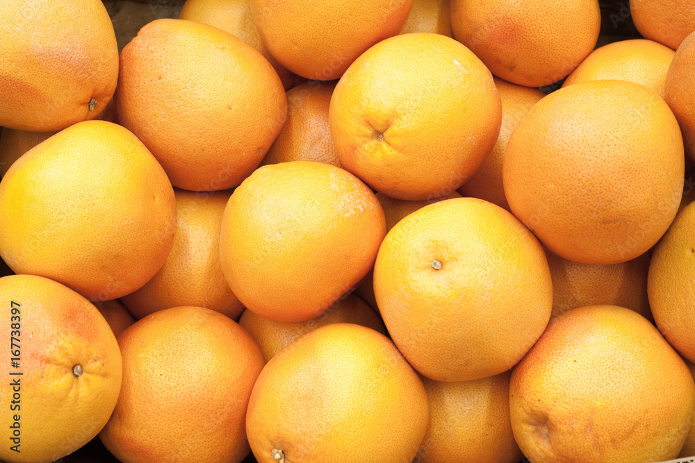 Juicy grapefruits in a big marketplace Grapefruit background Juicy grapefruits in a big marketplace Grapefruit background