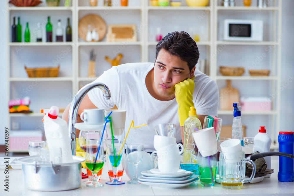 Man frustrated at having to wash dishes Man frustrated at having to wash dishes