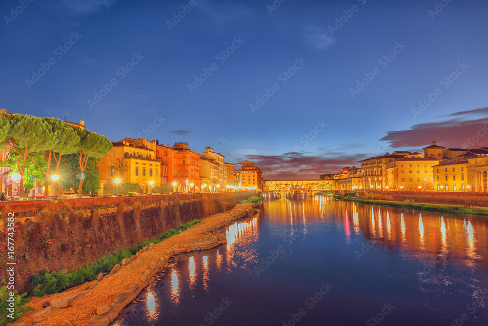 Beautiful landscape, panorama on historical view of the Florence - Ponte Vecchio is a bridge in Florence at night time. Italy.
