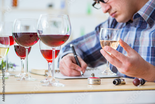 Professional sommelier tasting red wine 