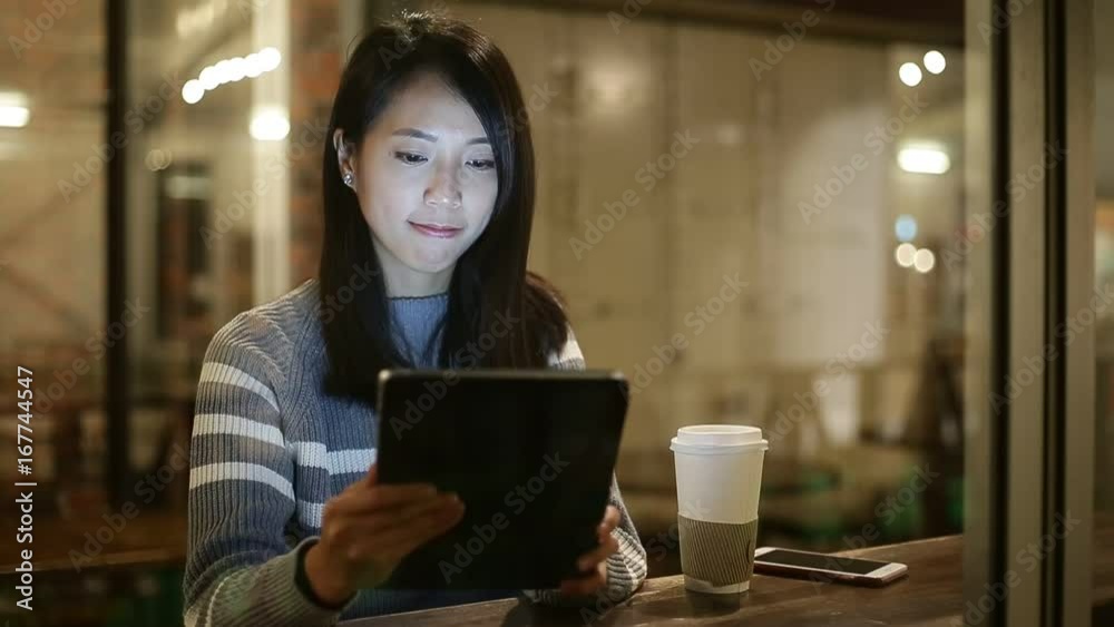 Woman use of digital tablet computer at coffee shop Woman use of digital tablet computer at coffee shop