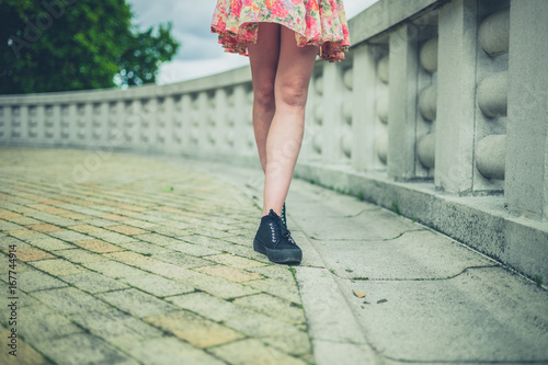 Legs of young woman by wall in city