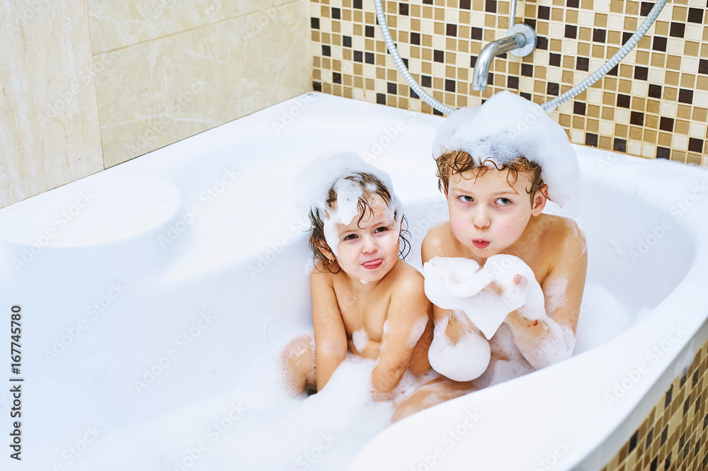 Children taking a bath .Cheerful brother and sister together take water treatments