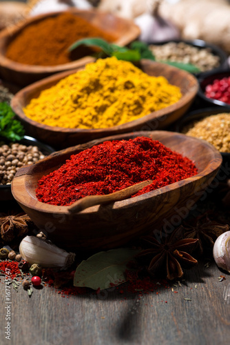 Fototapeta Naklejka Na Ścianę i Meble -  assortment of spices and herbs on a wooden table, closeup