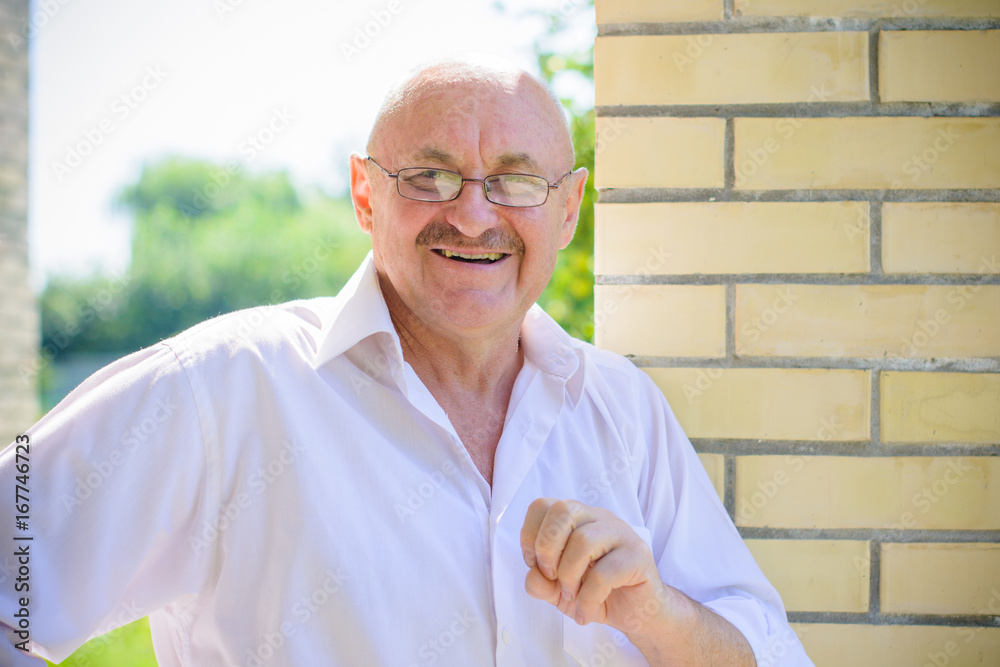 Mature european man in white shirt in eye glasses feeling happy and comfortable. A human with problem eyes enjoys life. Fun and joyful for every moment Mature european man in white shirt in eye glasses feeling happy and comfortable. A human with problem eyes enjoys life. Fun and joyful for every moment