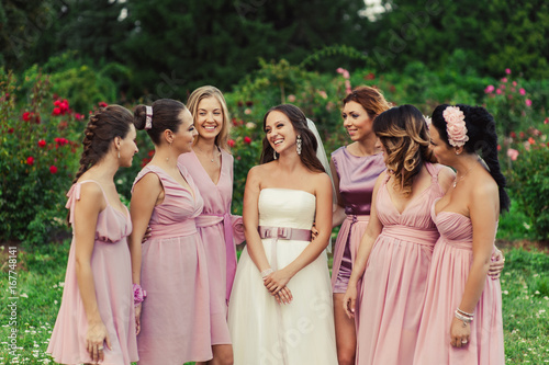 Bride with bridesmaids in pink dresses for a walk
