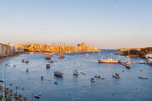 Valletta seafront skyline view across Marsamxett from Sliema, Malta. Panorama sunset view of Marsamxett harbour.