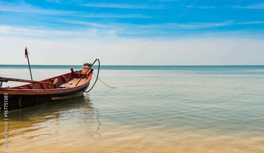 wooden fising boat on blue sky and sea beach wiht copy space.
