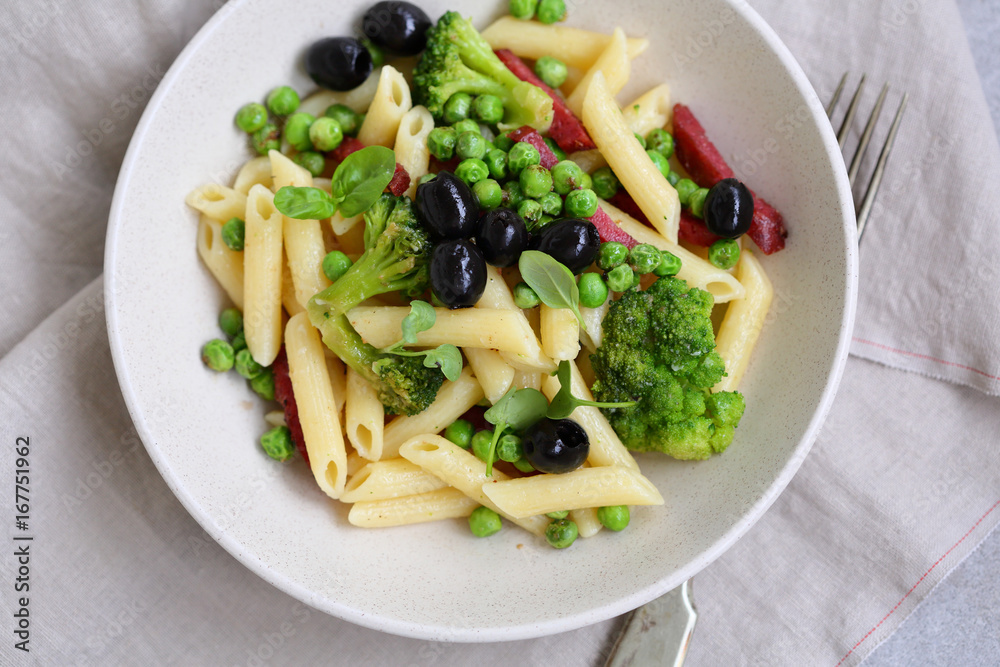 Pasta penne with salami and vegetables