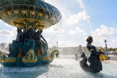 The Fountain of the Rivers in the Concorde square in Paris, France, with statues of Nereids and Tritons holding golden fishes spitting water to the upper basin. photo