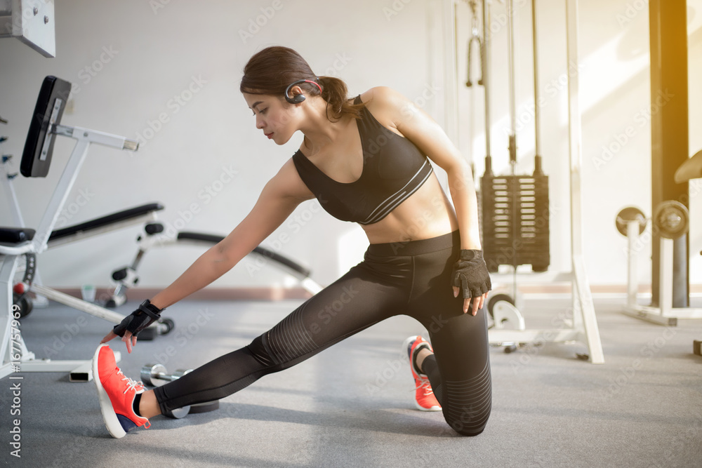 Fototapeta premium beautiful muscular fit woman exercising building muscles and fitness woman doing exercises in the gym. Fitness - concept of healthy lifestyle,soft focus