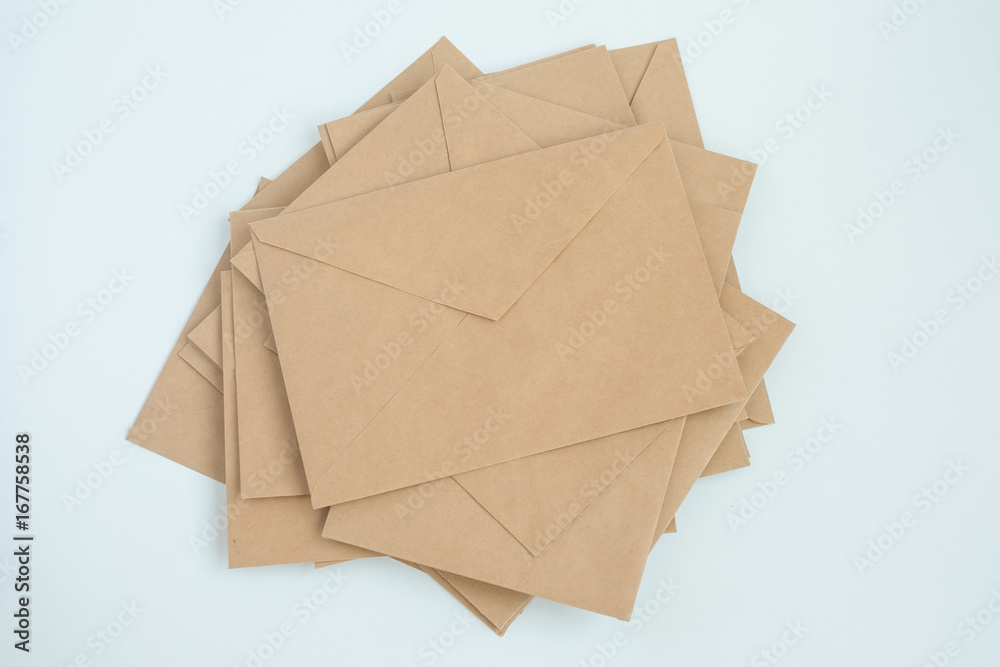 several envelopes from brown letter paper, on white background close-up, top view several envelopes from brown letter paper, on white background close-up, top view