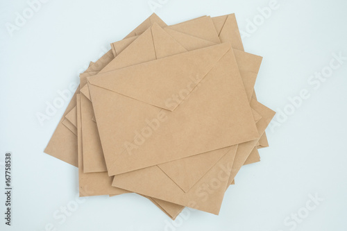 several envelopes from brown letter paper, on white background close-up, top view