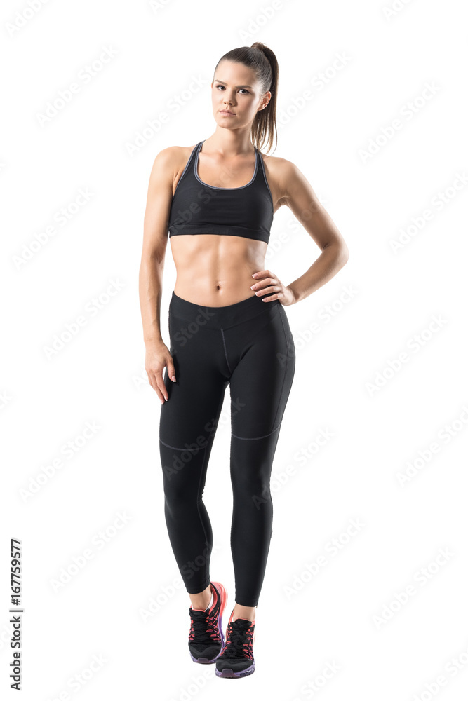 Portrait of a motivated slim fitness woman posing while standing with hands  on hips isolated over gray background Stock Photo - Alamy