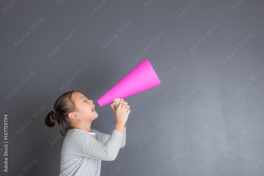 Kid shouting through pink paper megaphone. Kid shouting through pink paper megaphone.
