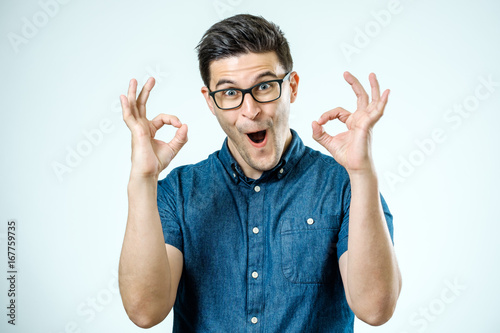 Slika na platnu Handsome man in jeans shirt showing ok sign