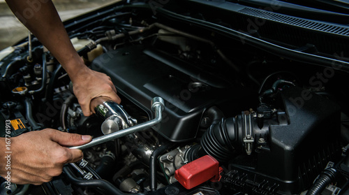Hand of mechanic is repairing car engine © magneticmcc