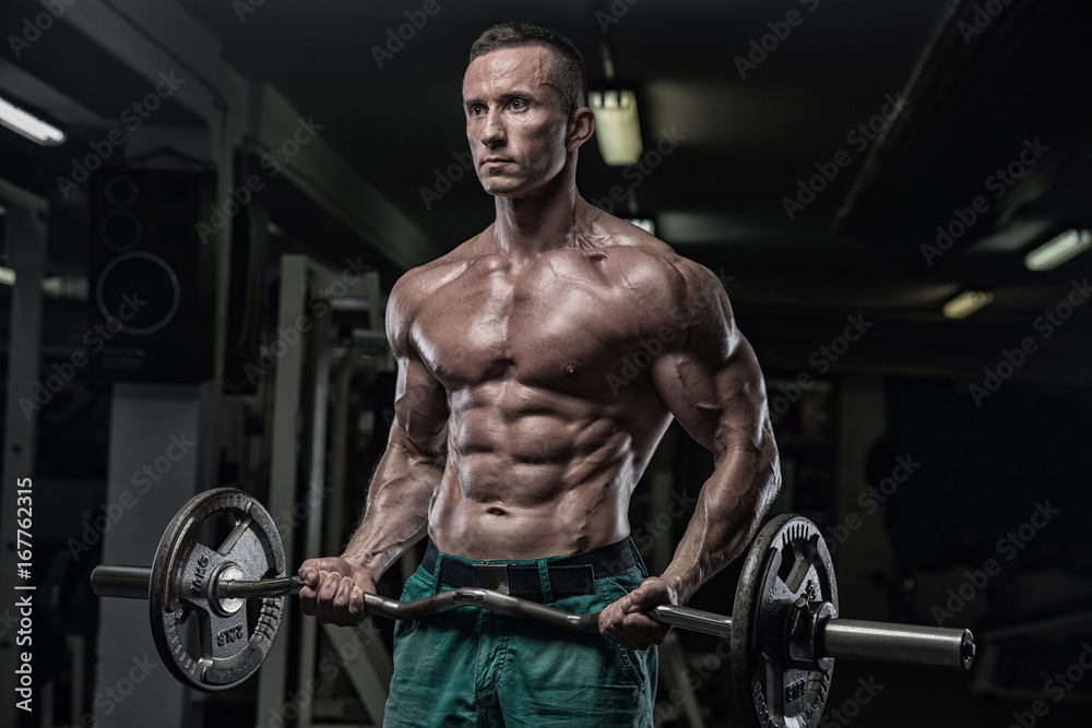 strong and handsome young man doing exercise with dumbbells strong and handsome young man doing exercise with dumbbells