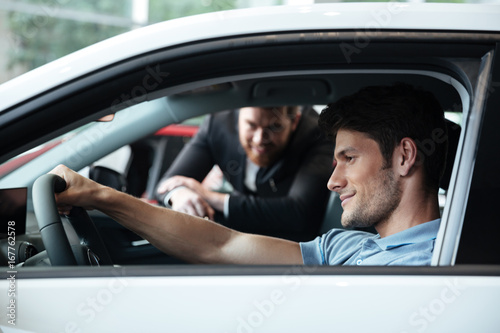 Young man testing his new car © Drobot Dean