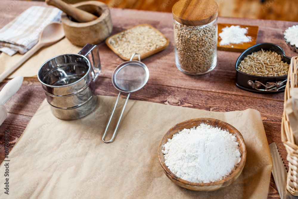 wheat and flour on rustic wooden table wheat and flour on rustic wooden table
