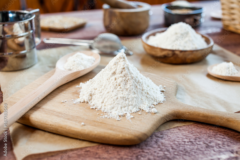 wheat and flour on rustic wooden table wheat and flour on rustic wooden table