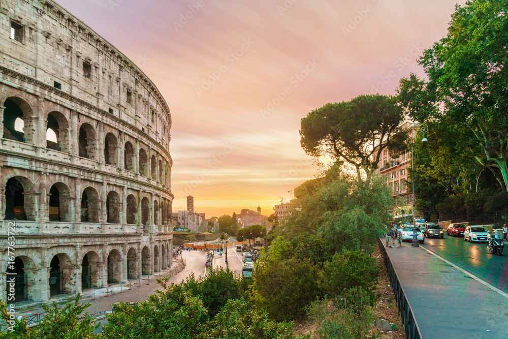Back view on colosseum at sunset time. 