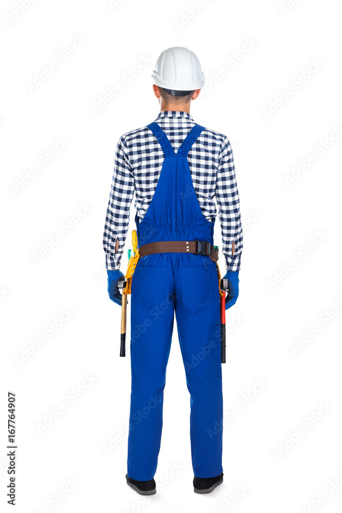 Back view of young construction worker in uniform and tool belt