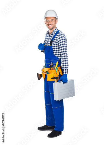Full length portrait of smiling construction worker in uniform with toolbox © GVS