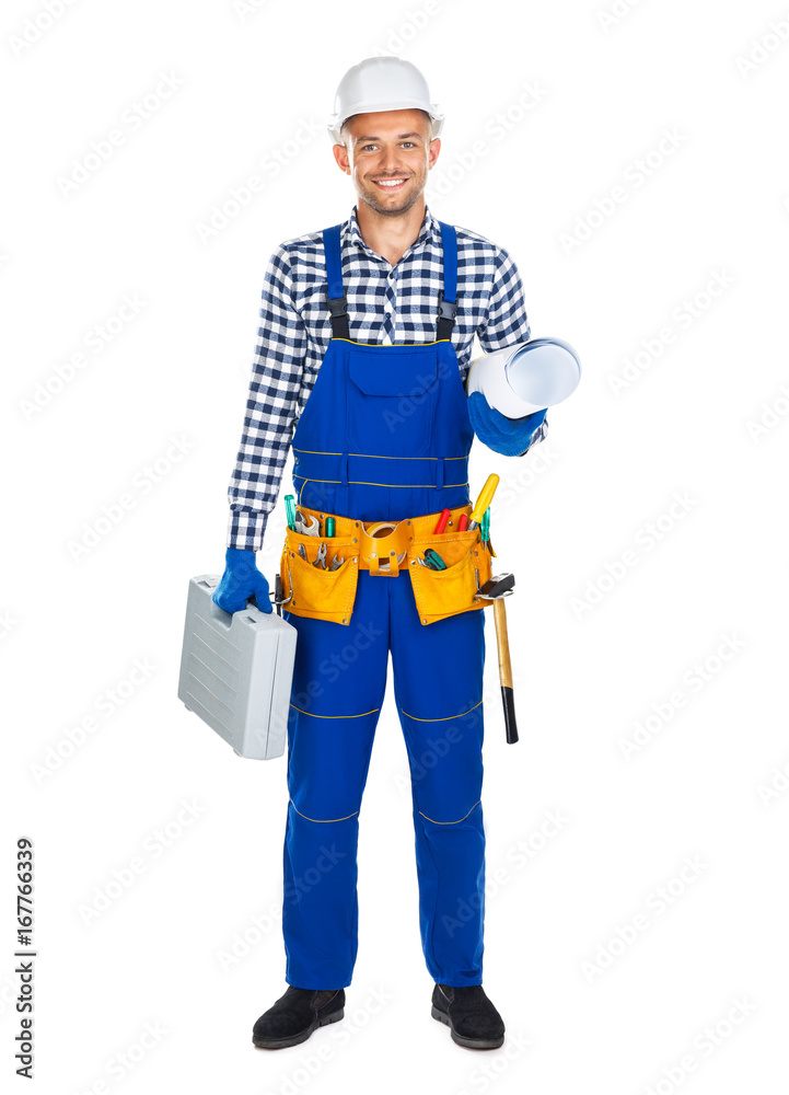 Full length portrait of happy construction worker in uniform with toolbox and drawings Full length portrait of happy construction worker in uniform with toolbox and drawings