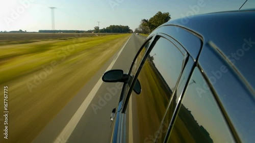 Driving a black sports / super car POV. Right side reference. Country road, trees on the side, fall, day. Fast Speed / time-lapse. HD. Right side wheel / driving UK 