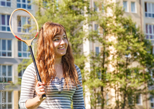 young beautiful woman playing badminton