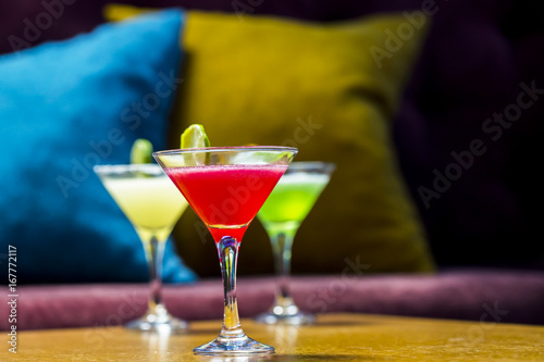 Three colorful cocktails in martini glasses photo