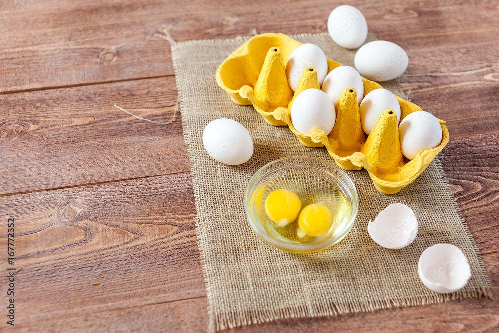 Close-up view of raw chicken eggs on wooden background Close-up view of raw chicken eggs on wooden background