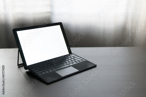 blank laptop screen mock up,empty screen workspace on laptop computer,working on desk concept,business office equipment,portable device and gadget accessories,selective focus and vintage tone