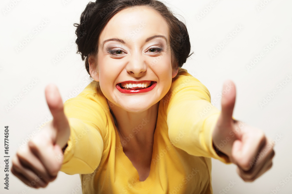 lifestyle, people and emotional concept: Happy Woman Showing Thu lifestyle, people and emotional concept: Happy Woman Showing Thu