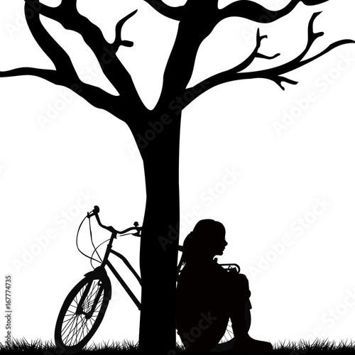Woman and bicycle leaned against a tree