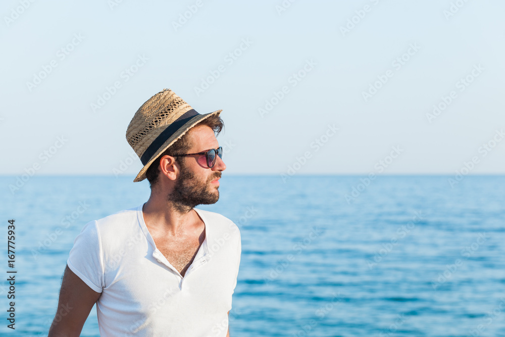 Young hipster man on the beach