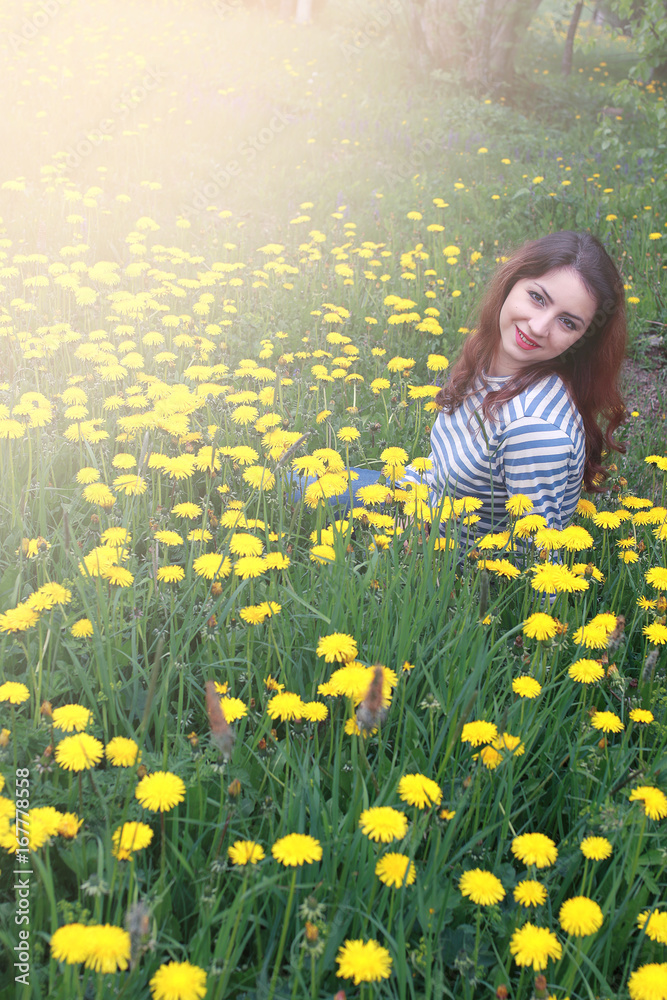 girl resting on a sunny day in meadow of yellow dandelions girl resting on a sunny day in meadow of yellow dandelions