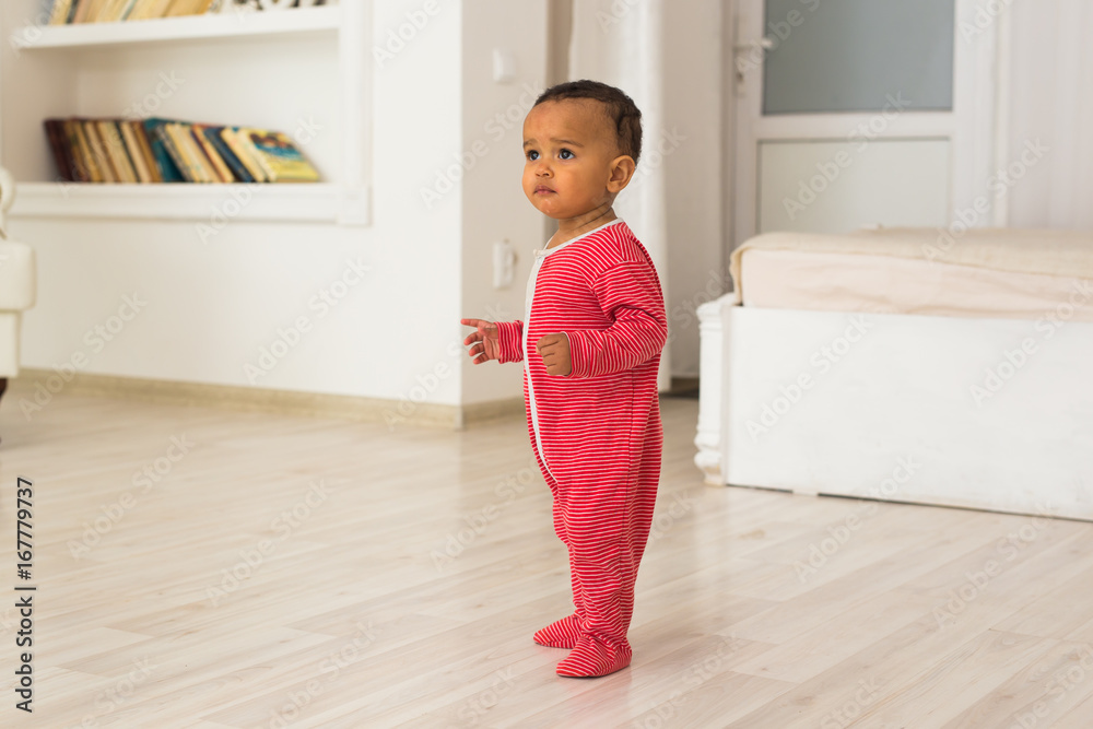 Full length portrait of mixed race baby boy in the home