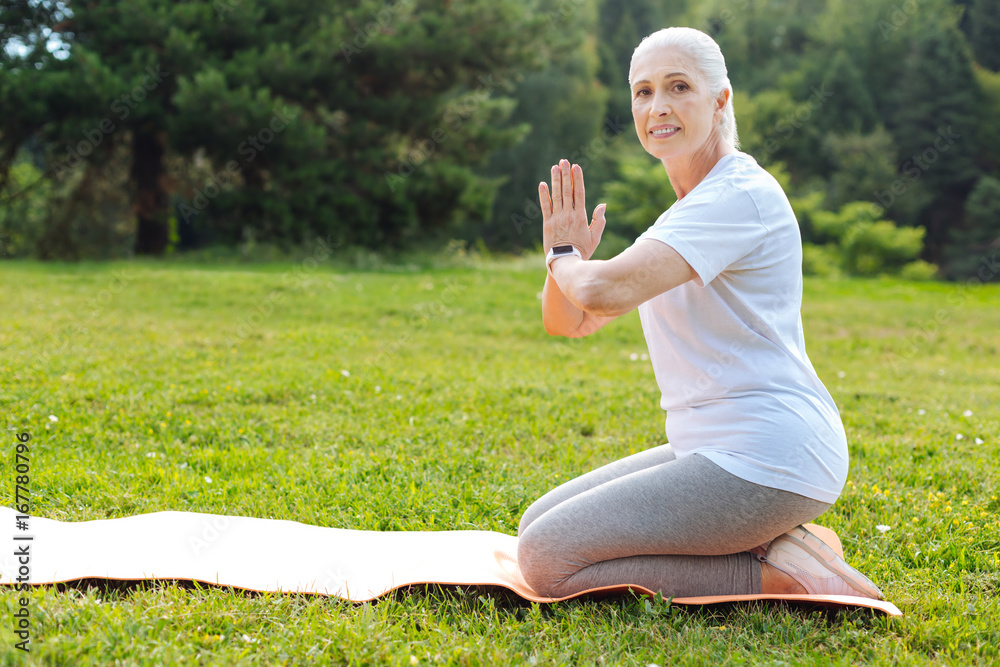 Fototapeta premium Delighted woman preparing for meditation