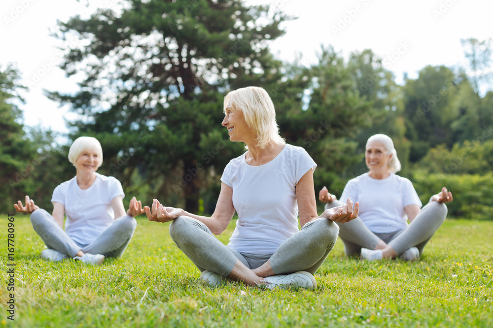 Fototapeta premium Joyful blonde woman looking at her friend