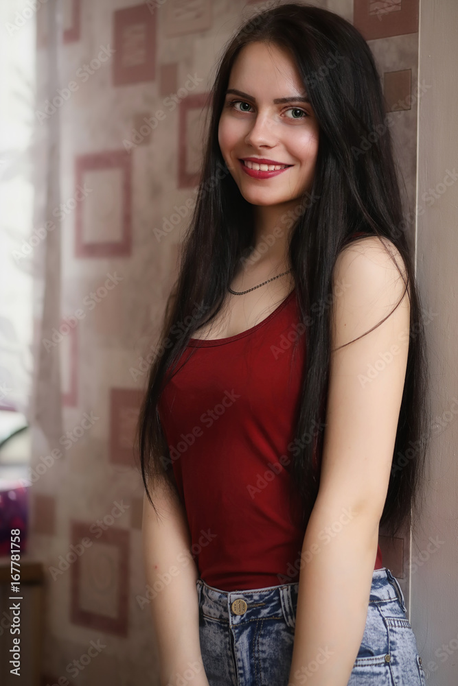 Fototapeta premium Pretty girl posing at camera in apartment